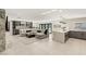 Open living area with a fireplace, bar, and modern kitchen island, perfect for gatherings at 6975 Darby Ave, Las Vegas, NV 89117