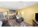 Comfortable living room with ample seating, a kitchenette area, and neutral-toned walls at 6975 Darby Ave, Las Vegas, NV 89117