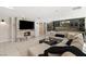 Bright living room boasts a stone fireplace, modern bar, and comfortable seating for entertaining guests at 6975 Darby Ave, Las Vegas, NV 89117