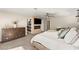 Large main bedroom showcasing neutral tones, a ceiling fan, a TV and fireplace, and ensuite bathroom access at 6975 Darby Ave, Las Vegas, NV 89117