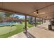 Covered patio featuring a golf putting green and swimming pool, creating a perfect outdoor entertainment space at 6975 Darby Ave, Las Vegas, NV 89117