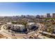 High-angle view showing multiple buildings, streets, greenery, and the Las Vegas skyline in the distance at 730 S Royal Crest Cir # 426, Las Vegas, NV 89169