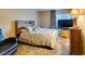 Bedroom featuring tile floors, a comfortable bed, a large television, and a matching nightstand at 730 S Royal Crest Cir # 426, Las Vegas, NV 89169