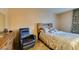 Cozy bedroom featuring tiled floors, a plush recliner, a comfortable bed, and matching dressers at 730 S Royal Crest Cir # 426, Las Vegas, NV 89169