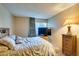 Bedroom featuring tile floors, a comfortable bed, a large television, and a matching nightstand at 730 S Royal Crest Cir # 426, Las Vegas, NV 89169