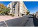 Exterior of condo building with parking, desert landscaping, and stairs at 730 S Royal Crest Cir # 426, Las Vegas, NV 89169