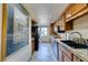 Updated kitchen offers granite countertops, stainless steel appliances, wood cabinetry, and tile floors at 730 S Royal Crest Cir # 426, Las Vegas, NV 89169