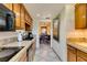 Efficient kitchen featuring granite countertops, black appliances, wooden cabinetry, and convenient access to the dining space at 730 S Royal Crest Cir # 426, Las Vegas, NV 89169