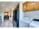 This kitchen is equipped with granite counters, appliances, and wooden cabinets, accompanied by a washer and dryer at 730 S Royal Crest Cir # 426, Las Vegas, NV 89169
