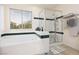 Bathroom featuring a soaking tub, glass enclosed shower, window, and tile floors at 7317 Bosky Springs St, Las Vegas, NV 89131