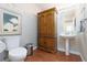 Bathroom featuring wooden cabinet, pedestal sink, and tiled floors at 7317 Bosky Springs St, Las Vegas, NV 89131