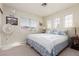 Bright bedroom featuring carpet flooring, neutral walls, windows, and a comfortable queen bed at 7317 Bosky Springs St, Las Vegas, NV 89131