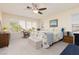 Bedroom with carpet flooring, a ceiling fan, and natural light from multiple windows at 7317 Bosky Springs St, Las Vegas, NV 89131