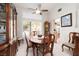Dining area featuring an ornate china cabinet, a ceiling fan, and ample light from a large window at 7317 Bosky Springs St, Las Vegas, NV 89131