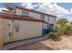 View of exterior with red tile roof, utilities, trash cans, and desert landscaping at 7317 Bosky Springs St, Las Vegas, NV 89131