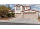Charming two-story home featuring a red tile roof, dual garages, and desert landscaping for eye-catching curb appeal at 7317 Bosky Springs St, Las Vegas, NV 89131