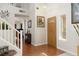 Welcoming home foyer with wood flooring, a staircase, and tasteful decor at 7317 Bosky Springs St, Las Vegas, NV 89131