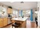 Kitchen with a central island, wood floors, and stainless steel appliances at 7317 Bosky Springs St, Las Vegas, NV 89131