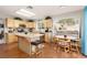 Open kitchen area with island seating, stainless appliances, granite countertops, and ample natural light at 7317 Bosky Springs St, Las Vegas, NV 89131