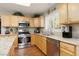 Bright kitchen featuring stainless steel appliances, granite countertops and wood flooring at 7317 Bosky Springs St, Las Vegas, NV 89131