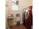 Bright laundry room with red washer and dryer, plus a window for ventilation at 7317 Bosky Springs St, Las Vegas, NV 89131