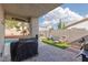 Covered patio featuring outdoor seating, a grill, and a view of the backyard and pool at 7317 Bosky Springs St, Las Vegas, NV 89131