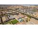 Aerial view of a home showcasing a pool, artificial turf, and neighborhood amenities in a planned community at 792 Drammatico Pl, Henderson, NV 89011