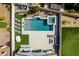 Stunning aerial view of a backyard oasis with pool, spa, and lounging area at 792 Drammatico Pl, Henderson, NV 89011