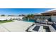 Stunning backyard with a pool, spa, lounge area, artificial grass, and covered patio with outdoor seating at 792 Drammatico Pl, Henderson, NV 89011