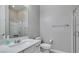Modern bathroom featuring a glass shower, white vanity with solid surface counter and neutral wall color at 792 Drammatico Pl, Henderson, NV 89011