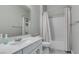 Functional bathroom with a single sink vanity, toilet, and a shower-tub combination with curtain at 792 Drammatico Pl, Henderson, NV 89011