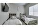 Well-lit bedroom featuring two beds, a mounted TV, and a window providing natural light at 792 Drammatico Pl, Henderson, NV 89011