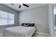 Simple bedroom with a full-size bed, a window, and an en-suite bathroom, offering a private retreat at 792 Drammatico Pl, Henderson, NV 89011