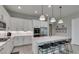 Modern kitchen with quartz countertops, white cabinets, and stainless steel appliances at 792 Drammatico Pl, Henderson, NV 89011