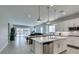 Open-concept kitchen with white cabinetry, stainless steel appliances, and island at 792 Drammatico Pl, Henderson, NV 89011