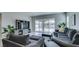 Comfortable living room with plush seating, stylish decor, and backyard views at 792 Drammatico Pl, Henderson, NV 89011
