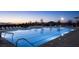 Stunning community pool featuring lounge chairs, mountain views, and clear blue water at 792 Drammatico Pl, Henderson, NV 89011
