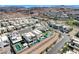 Panoramic aerial shot of modern community homes with pools, set against a backdrop of desert hills and mountains at 795 Glistening Light Ct, Henderson, NV 89052