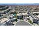 Aerial view of modern homes with solar panels, pools, and green spaces within a vibrant community at 795 Glistening Light Ct, Henderson, NV 89052