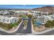 Aerial shot showing a desert community of modern homes, complemented by stylish landscaping and mountain vistas at 795 Glistening Light Ct, Henderson, NV 89052