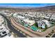 A landscape aerial shot displays homes with pools in a desert community, showcasing modern architecture at 795 Glistening Light Ct, Henderson, NV 89052