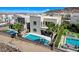 Aerial view of a modern home with a pool, spa, and lush landscaping at 795 Glistening Light Ct, Henderson, NV 89052