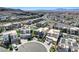 Aerial view capturing residences in a modern neighborhood, highlighting desert landscaping and mountain views at 795 Glistening Light Ct, Henderson, NV 89052