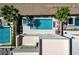 Lush backyard features a sparkling pool, hot tub, patio seating, and modern landscaping at 795 Glistening Light Ct, Henderson, NV 89052