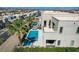 A captivating aerial view of a backyard with a large swimming pool, landscaping, and a modern architectural style at 795 Glistening Light Ct, Henderson, NV 89052