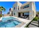 Backyard featuring a pool, spa, patio, and lush landscaping for outdoor enjoyment at 795 Glistening Light Ct, Henderson, NV 89052
