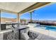 Outdoor oasis with a built-in grill, dining area, and sparkling pool offers resort-style living at 795 Glistening Light Ct, Henderson, NV 89052