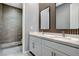 Elegant bathroom with dual sinks, a large mirror, and a glass-enclosed shower offers modern luxury at 795 Glistening Light Ct, Henderson, NV 89052