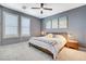 Relaxing bedroom with bright windows, modern art, and a plush bed create a serene atmosphere at 795 Glistening Light Ct, Henderson, NV 89052