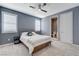 Cozy bedroom featuring large windows, ceiling fan and ensuite bathroom at 795 Glistening Light Ct, Henderson, NV 89052
